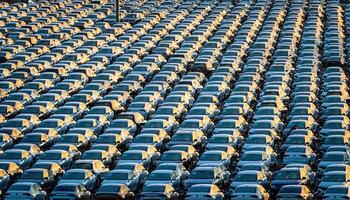 Volkswagen Group Rus, Russia, Kaluga - MAY 25, 2020 Rows of a new cars parked in a distribution center on a sunny morning in the autumn. photo