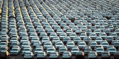 Volkswagen Group Rus, Russia, Kaluga - MAY 25, 2020 Rows of a new cars parked in a distribution center on a sunny morning in the autumn. photo