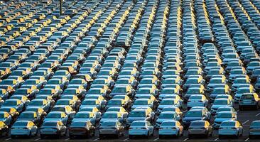 Volkswagen Group Rus, Russia, Kaluga - MAY 25, 2020 Rows of a new cars parked in a distribution center on a sunny morning in the autumn. photo