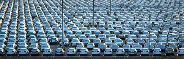 Volkswagen Group Rus, Russia, Kaluga - MAY 25, 2020 Rows of a new cars parked in a distribution center on a sunny morning in the autumn. photo