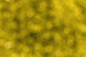 Blurred bokeh background image of bright yellow foliage in golden autumn. photo