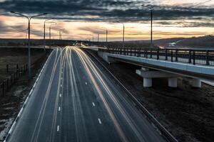 Moving car with blur light through twilight city. photo