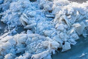 Melting ice floating on the river on a spring day. Cracked ice texture. photo