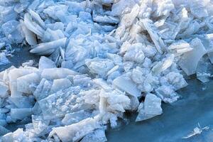 Melting ice floating on the river on a spring day. Cracked ice texture. photo