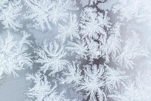 The texture of the glass covered with frost in winter in cold weather. Abstract background. photo