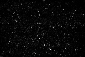 White snow on a black background texture. photo