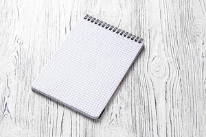 The notebook on a white table with a copy space. photo