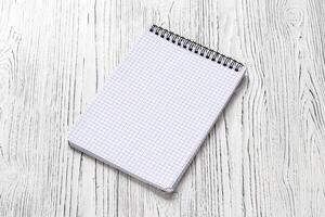 The notebook on a white table with a copy space. photo