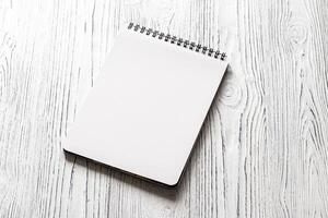 The notebook on a white table with a copy space. photo