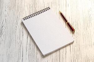The notebook and pen on a white table with a copy space. photo