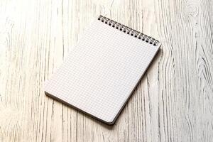 The notebook on a white table with a copy space. photo
