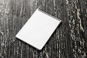 The notebook on a black table with a copy space. Template for mock up and presentation design. photo