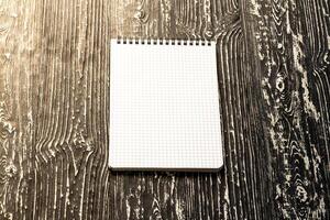 The notebook on a black table with a copy space. Template for mock up and presentation design. photo