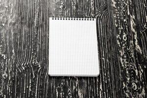 The notebook on a black table with a copy space. Template for mock up and presentation design. photo
