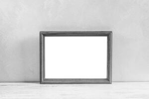 Wooden floor over concrete or decorative plaster wall and photo frame with copy space for a text background.