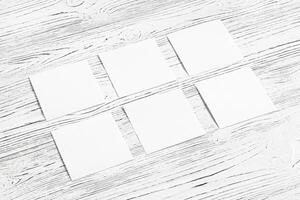 White paper sheets on a wooden table. Abstract background for design. photo