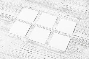 White paper sheets on a wooden table. Abstract background for design. photo