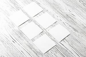White paper sheets on a wooden table. Abstract background for design. photo