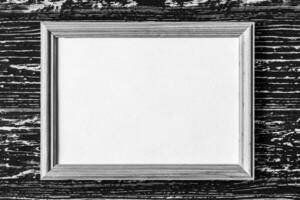 Photo frame on a wooden table. Abstract background for design.