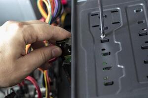Hands of the technician repairing a computer. Hardware instalation. photo
