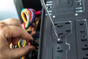 Hands of the technician repairing a computer. Hardware instalation. photo
