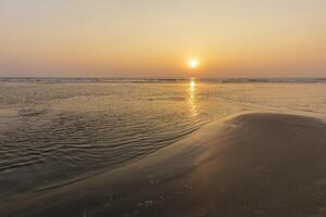 Sunset on Mandrem beach in Goa, India. photo