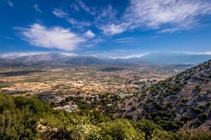 Top view of the Lassithi Plateau on a sunny clear day with a cloudy sky in the background. Crete island. photo