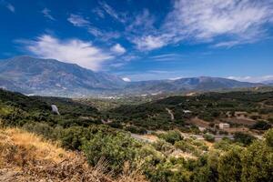 Mountains on the island of Crete on a clear sunny summer day with a cloudy sky. photo