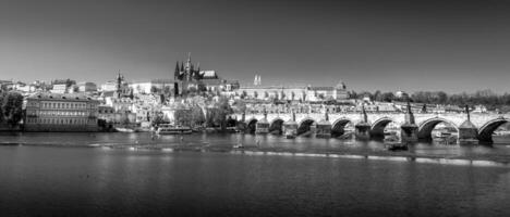 Charles bridge and Prague Castle panorama. Capital of the Czech republic. Sunny day. Black and white photo. photo