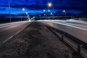 Moving car with blur light through twilight city. photo