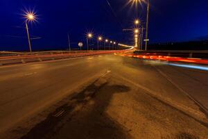 Moving car with blur light through twilight city. photo