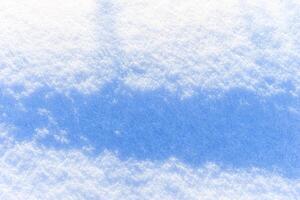 Snow texture at sunny winter day. Abstract background. photo