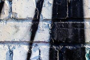 Fragment of colored graffiti painted on a brick wall. Abstract background for design. photo