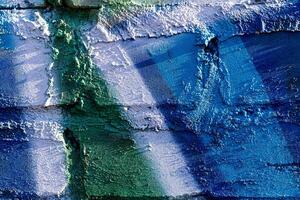 Fragment of colored graffiti painted on a brick wall. Abstract backdrop for design. photo
