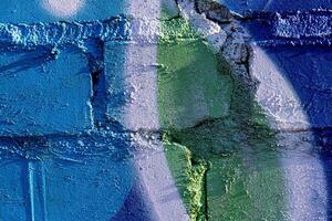 Fragment of colored graffiti painted on a brick wall. Abstract background for design. photo