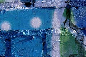 Fragment of colored graffiti painted on a brick wall. Abstract backdrop for design. photo