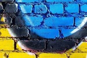 Fragment of colored graffiti painted on a brick wall. Abstract backdrop for design. photo