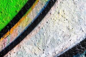 Fragment of colored graffiti painted on a concrete wall. Abstract background for design. photo