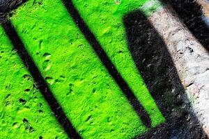 Fragment of colored graffiti painted on a concrete wall. Abstract background for design. photo