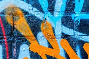 Fragment of colored graffiti painted on a wall. Bright abstract background. photo