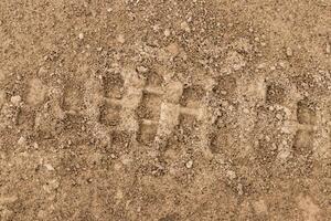 Texture of tire tracks on dry ground. photo
