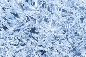 Texture of ice in the winter. Abstract background for design, photographed closeup. photo