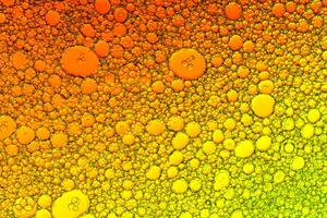Colorful drops of oil on the water. photo