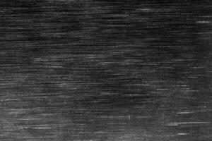 Black metal texture with white scratches. Abstract noise black background overlay. photo