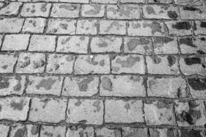 Top view on paving stone road. Old pavement of granite texture. photo