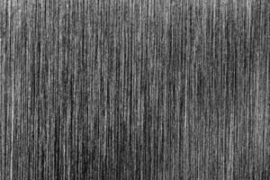 Metal texture with white scratches. Abstract noise black background overlay for design. photo