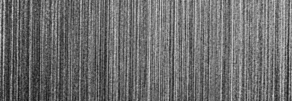 Metal texture with white scratches. Abstract noise black background overlay for design. photo