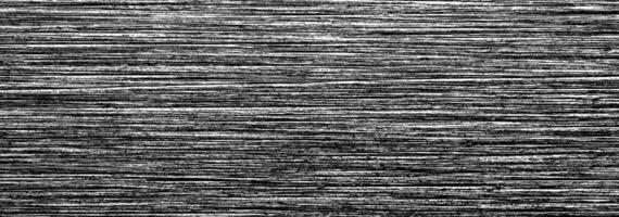 Metal texture with white scratches. Abstract noise black background overlay for design. photo
