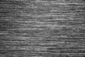 Metal texture with white scratches. Abstract noise black background overlay for design. photo