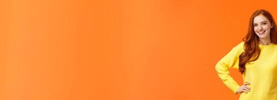 Sounds good, count me in. Waist-up shot cheerful upbeat girl make thumb-up gesture and smiling in approval, like idea, recommend consumer nice product, standing orange background photo